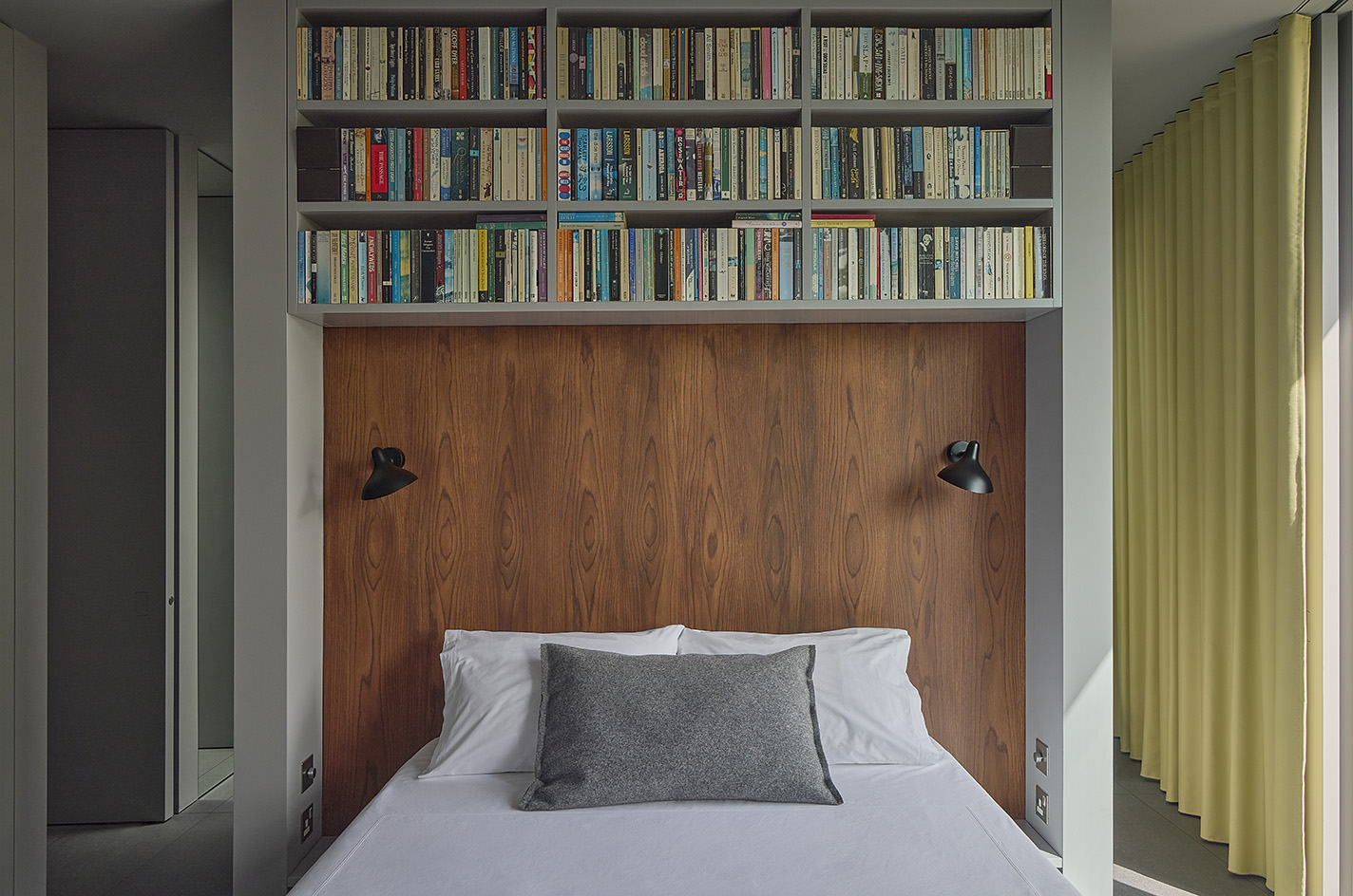 Clerkenwell Rooftop apartment in London, showing minimalist concrete and large openings with terrace and views out to urban views with green
