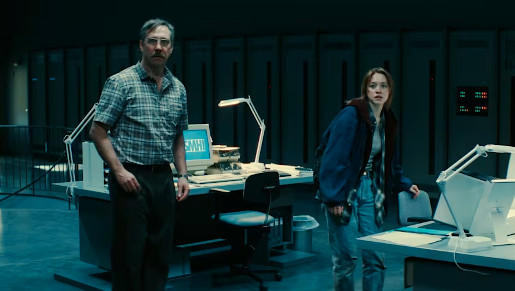 A man and a teenage girl are startled in an office
