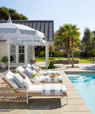 outdoor furniture and parasols by Serena & Lily next to pool