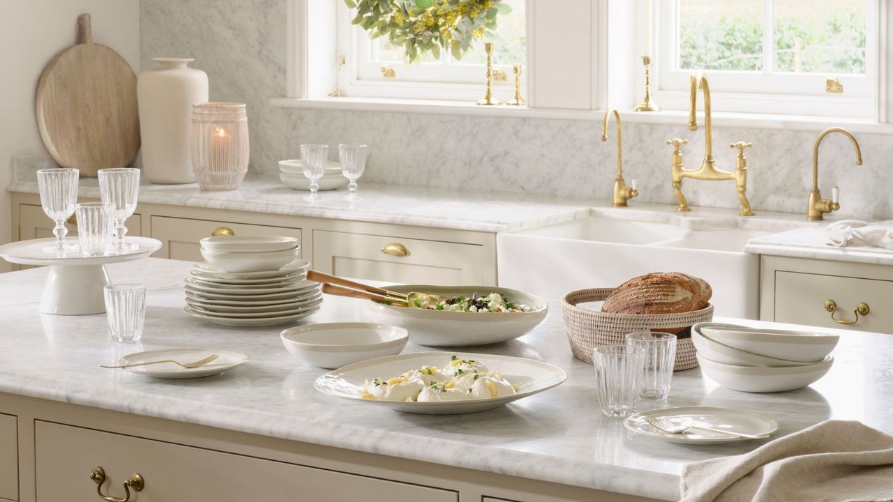 A marble kitchen island covered in plates of food