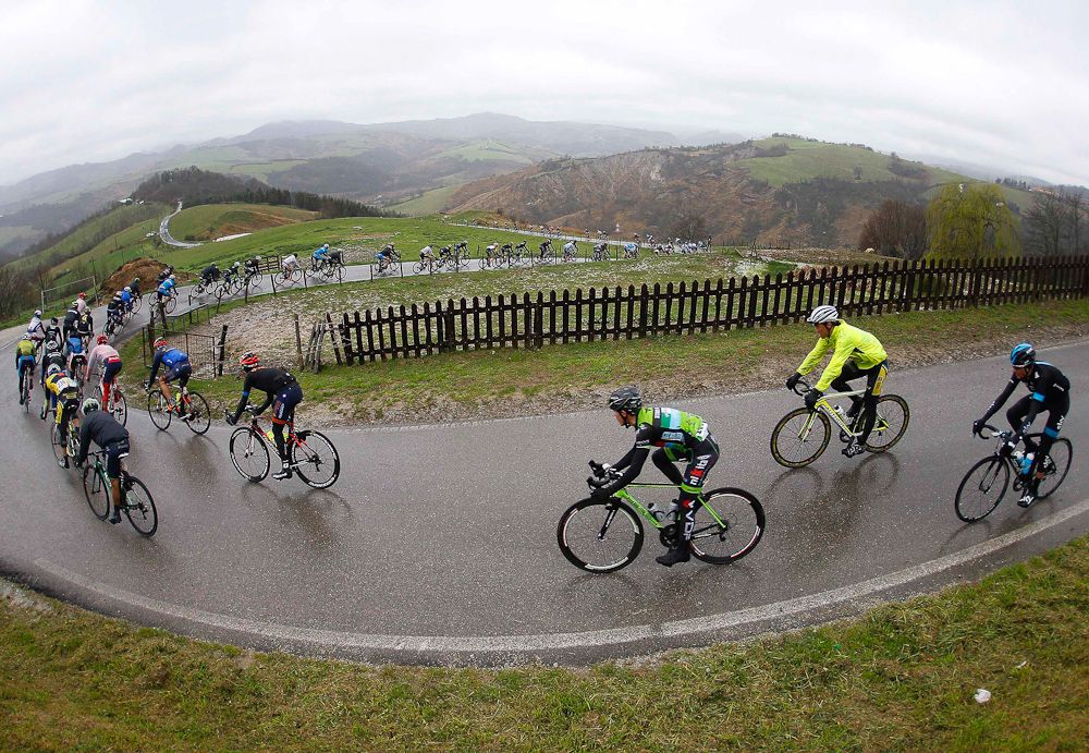 Riders take a corner in the rain.