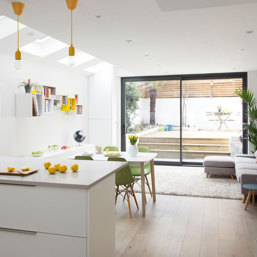 kitchen with white walls white cabinets and glass sliding doors