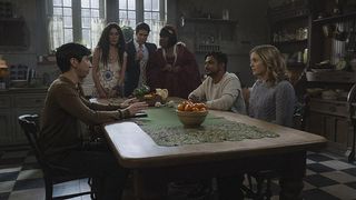 Freddie, Rose and Jay sit at the table with the Ghosts stood around them in Ghosts season 2