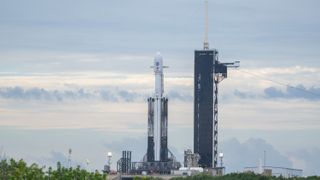 a falcon heavy rocket with sooty side boosters stands at lc-39a for NASA's Psyche mission, Oct. 11, 2023.