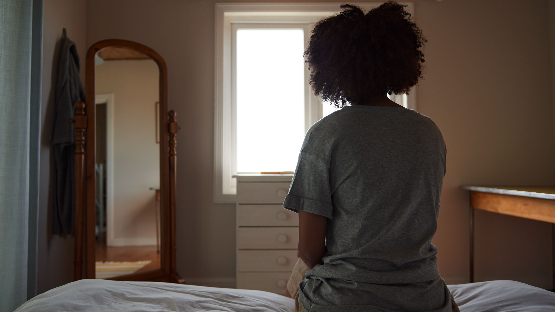 Woman sitting on the edge of a mattress