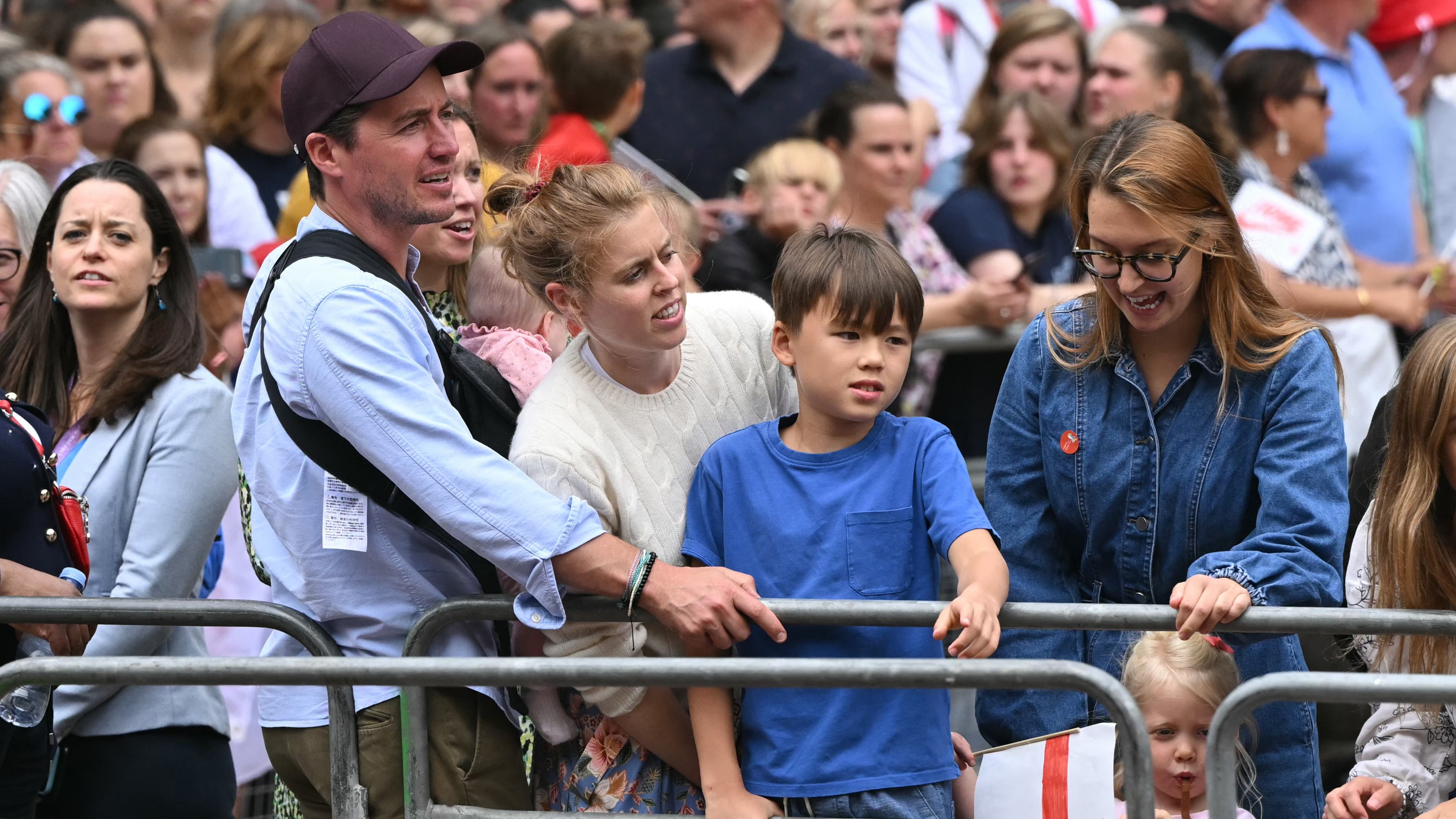 Princess Beatrice of York (C) her husband Edoardo Mozzi (CL) and children Sienna, Athena and Christopher joins fans lining the Mall
