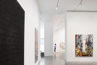 Bright interior of gallery with art work hanging on walls
