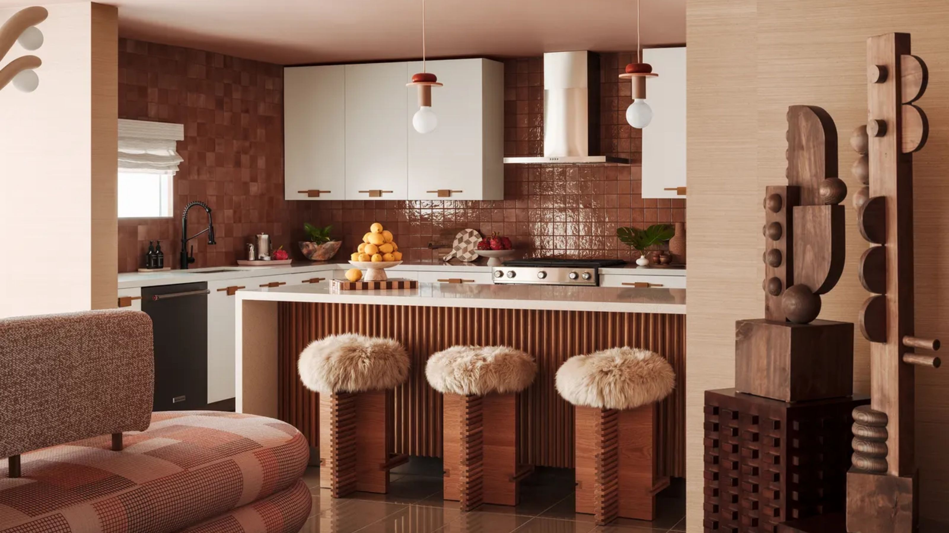 Tiled kitchen with Island and bar stools.