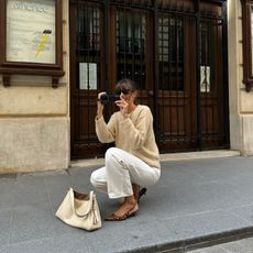 French fashion influencer Julie Sergent Ferreri wearing a chic fall sweater outfit in Paris. 