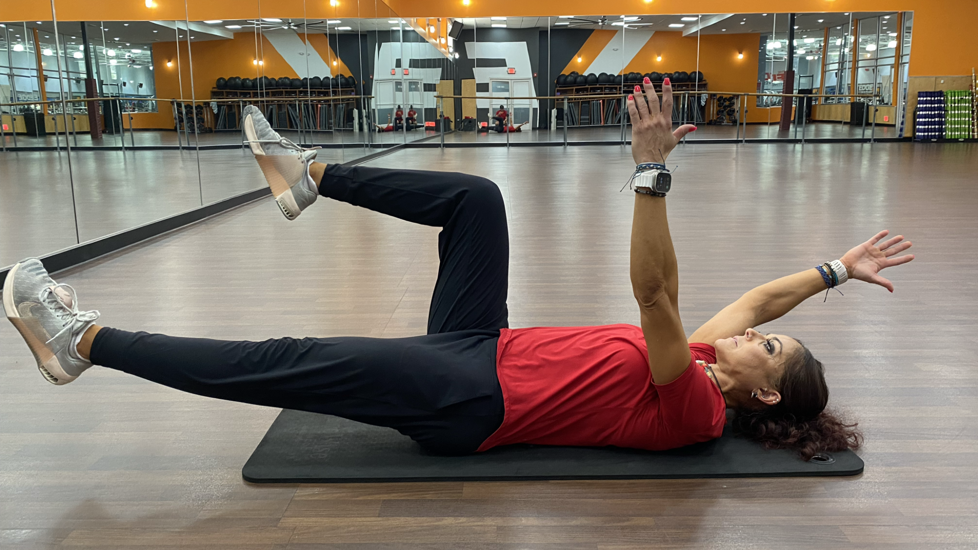 woman does core exercise on mat