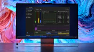 Lenovo PC displaying Task Manager OG with CPU and memory statistics, set against a colorful abstract background.
