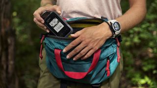 Woman using Garmin eTrex Solar device while hiking