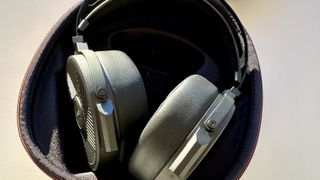 The Fiio FT5 headphones in their case, opened, outside on a warm day