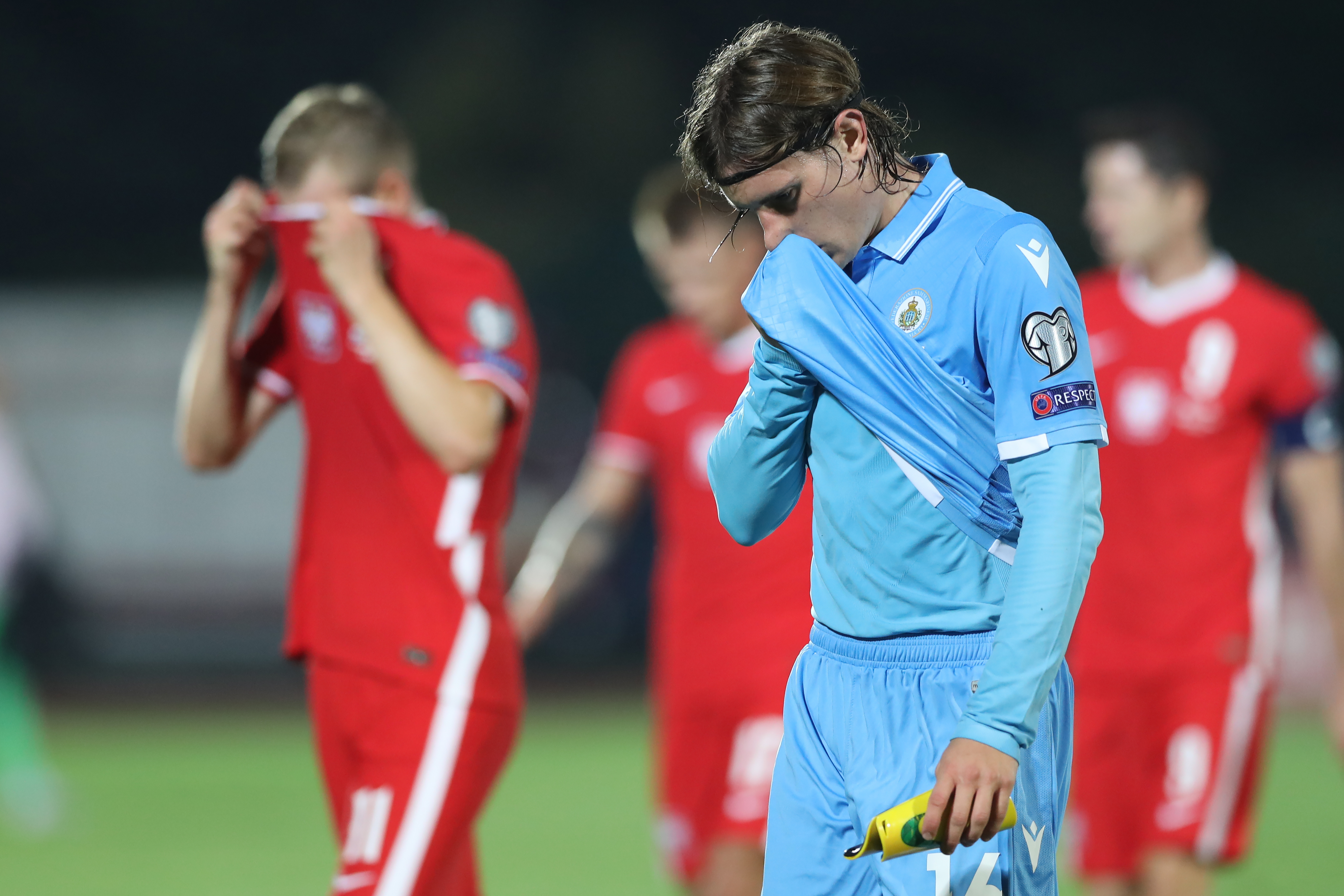 SAN MARINO, SAN MARINO - SEPTEMBER 05: Filippo Fabbri of San Marino reacts as the team enter the half time break trailing by 4-0 whilst Karol Swiderski of Poland reacts after missing a chance to increase the side's lead in the 2022 FIFA World Cup Qualifier match between San Marino and Poland at San Marino Stadium on September 05, 2021 in San Marino, San Marino. (Photo by Jonathan Moscrop/Getty Images)