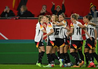 Germany's forward Selina Cerci (C) celebrates scoring the opening goal with her teammates during the women's friendly football match Germany vs Australia in Duisburg, western Germany on October 28, 2024.