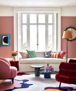 pink living room with beige couch and patterned throw pillows