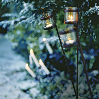 walkway with candles and snow