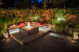 how to plan garden lighting: seating area with fire pit and lighting