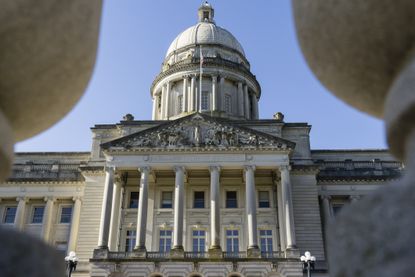 low camera angle of the capitol building in Kentucky against a blue sky