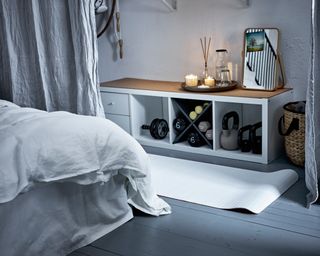 A workout area with curtains and yoga mat in a bedroom