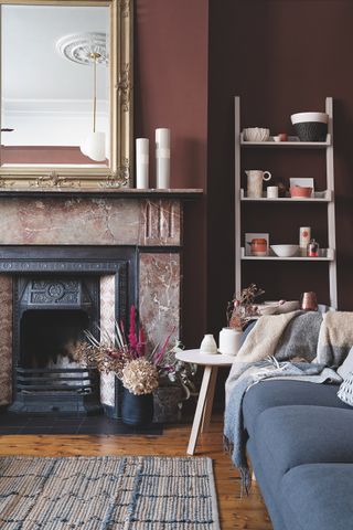 dark red living room snug with restored fireplace