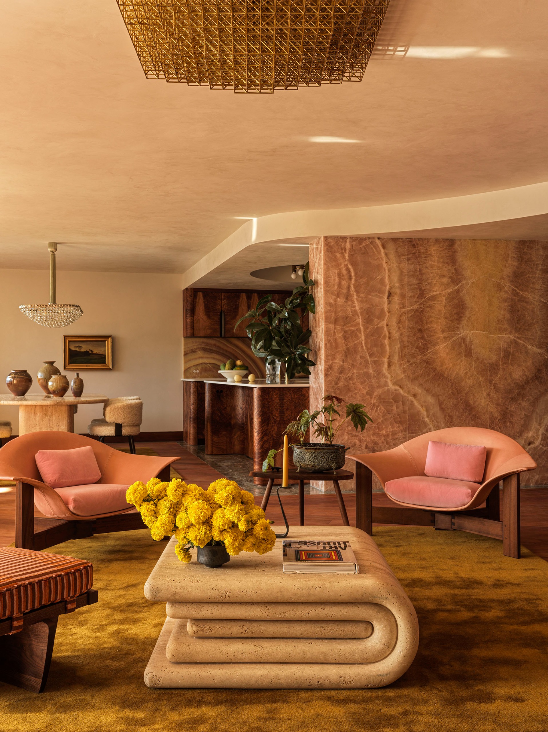 a living room with a tonally similar palette, but across materials including stone, burl wood, plush carpet and polished plaster