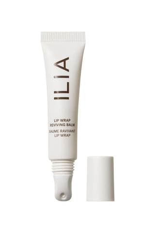 An unopened white tube of ILIA Lip Wrap against a white background.