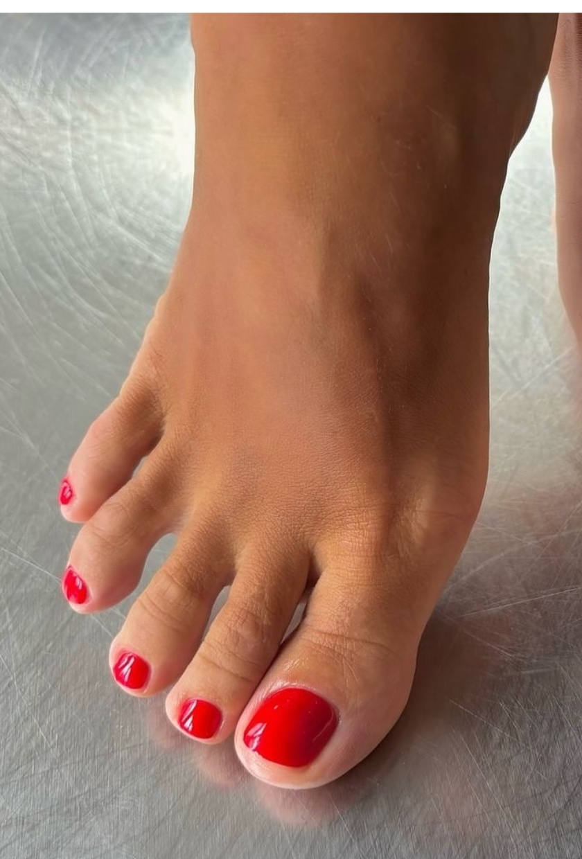 a close-up shot of a bright red pedicure