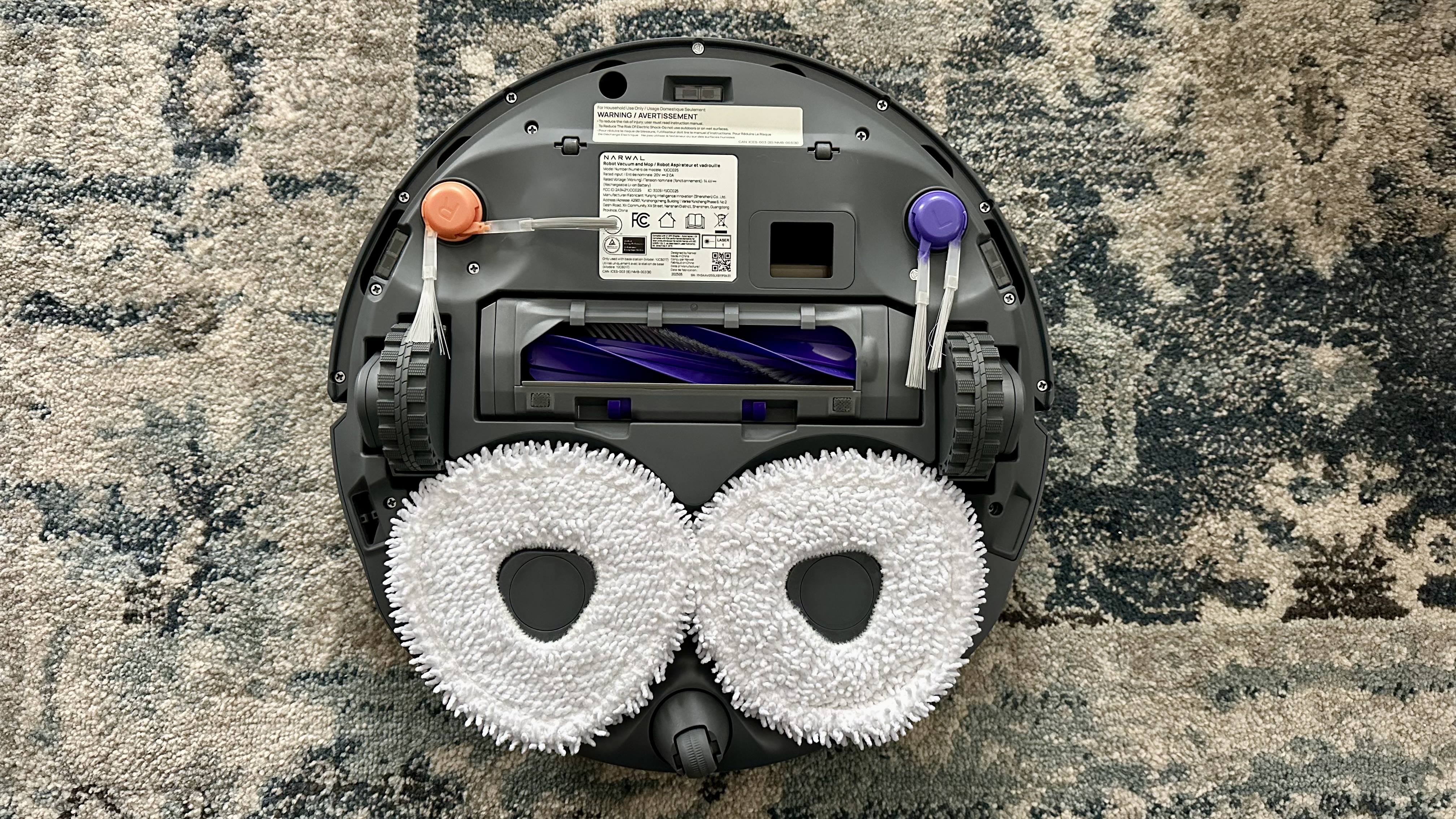 Underside of robot with tangle-free main brush, side brush, and microfiber triangular mopping pads