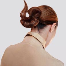 Woman with long hair up in an artistic bun