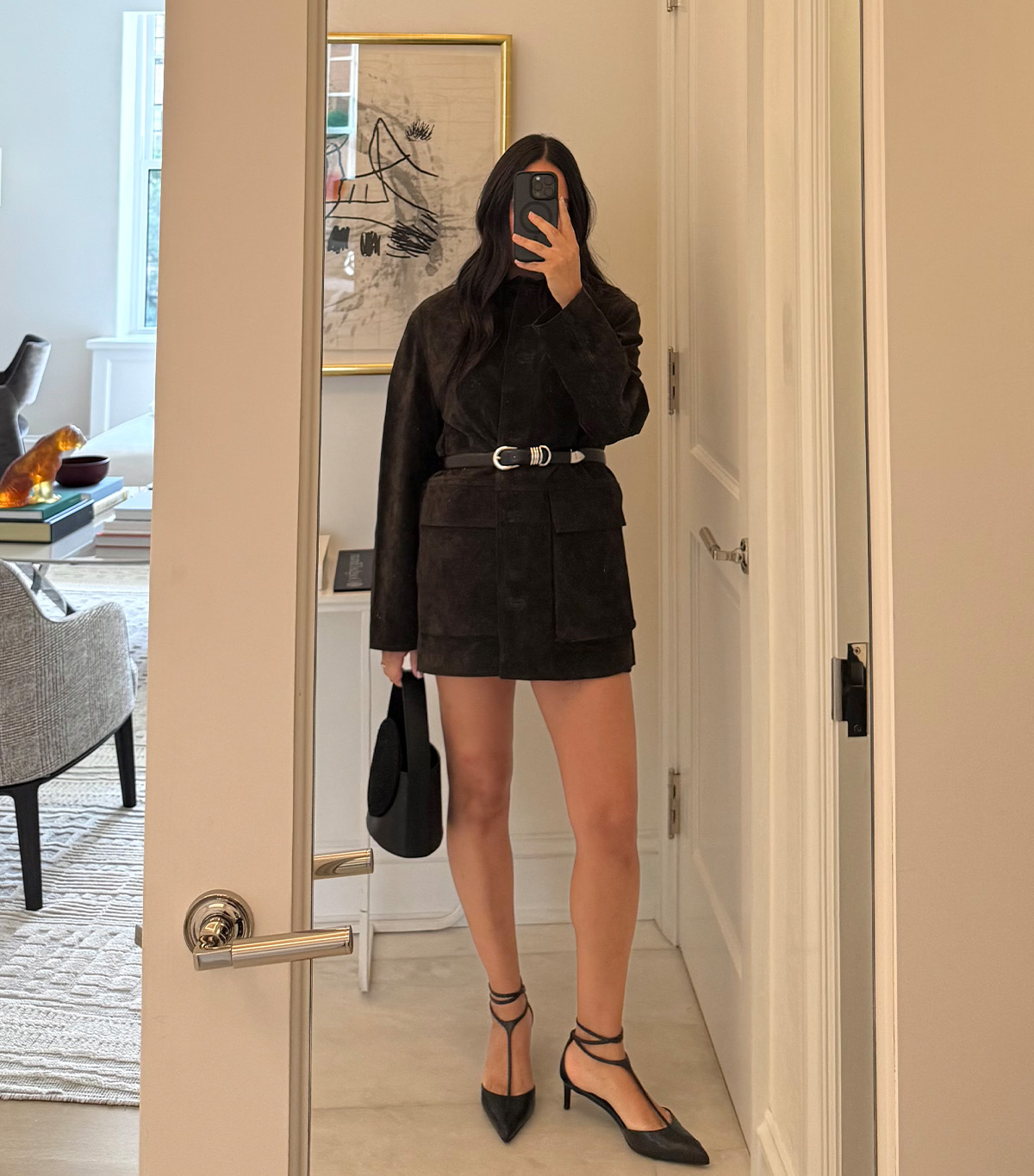 @nicoleakhtarzad taking a mirror selfie wearing a winter outfit.