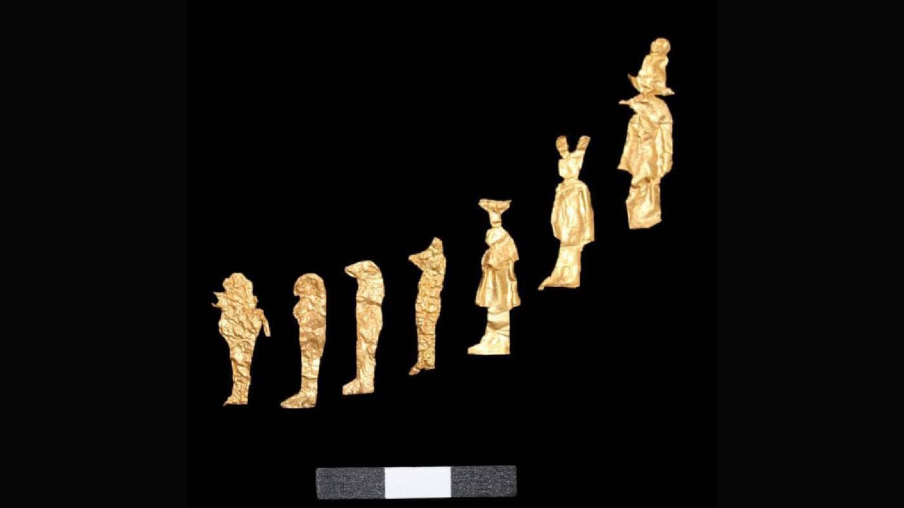Gold figurines are laid out in a diagonal line