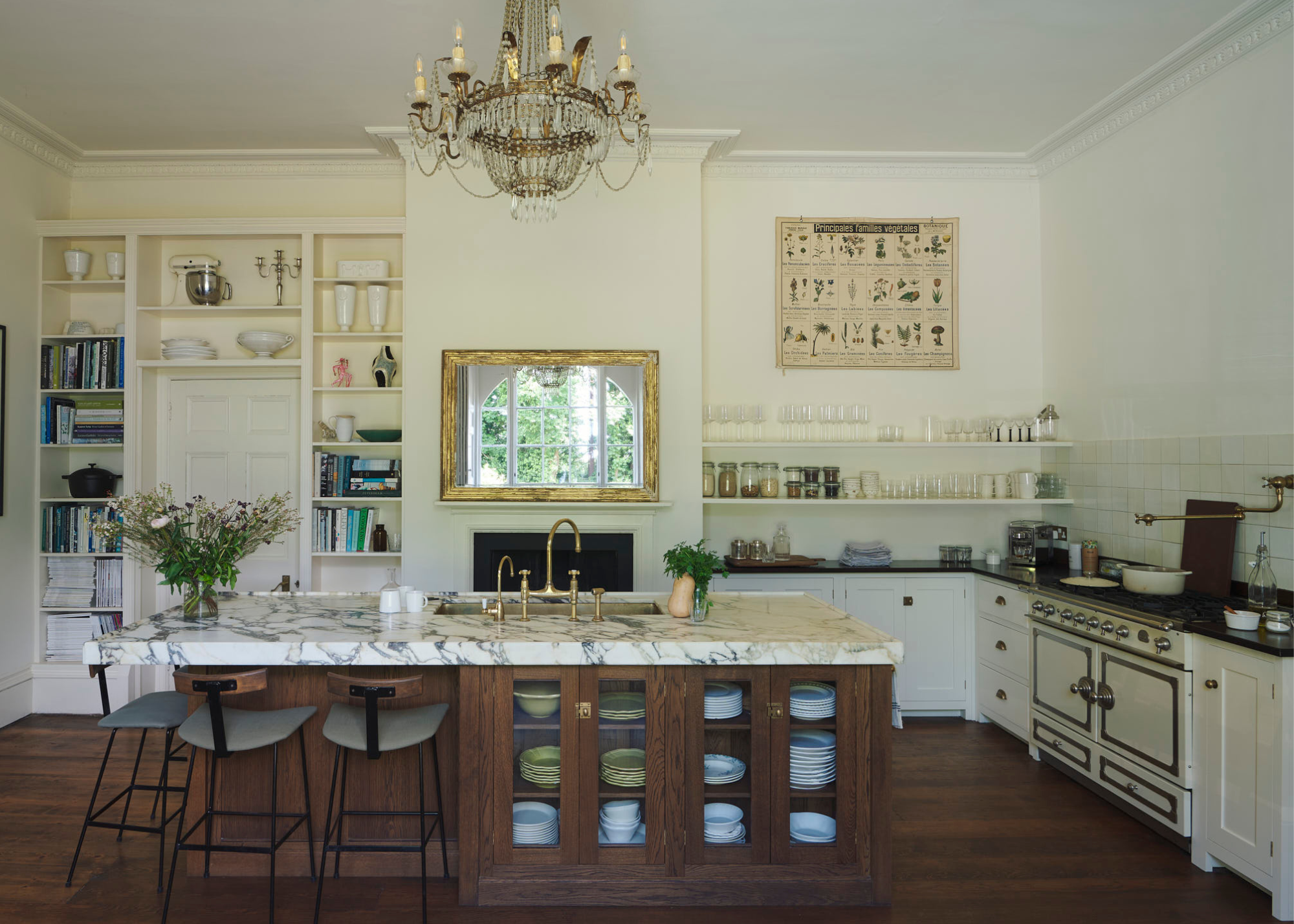 large traditional english kitchen with white cabinet, a wooden island and marble counters