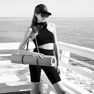 Kaia Gerber wearing Celine Pilates in front of a malibu pier