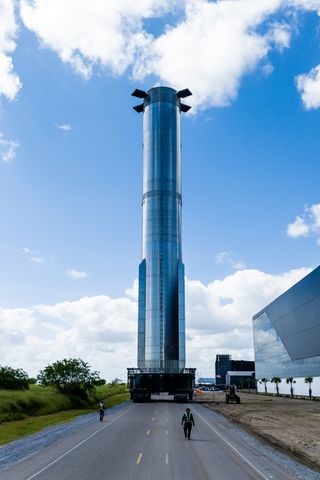 The Super Heavy rocket, which hefts SpaceX's Starship, on its way to a Starbase facility.