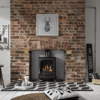 Arada Holborn stove in exposed brick fireplace with tiled hearth