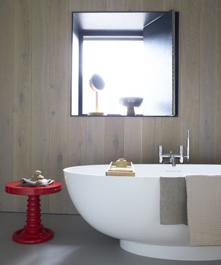 contemporary bathroom with red side table