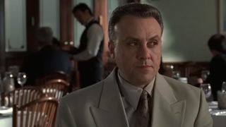 Johnny Sack in a sharp suit, looking to his left skeptically in The Sopranos