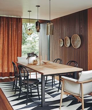 dining room with table, chairs, monochrome patterned rug