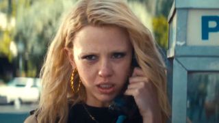 Mia Goth as Maxine Minx talks on a pay phone in the trailer for MaXXXine.