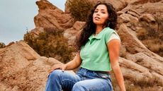 Woman in green vest and jeans