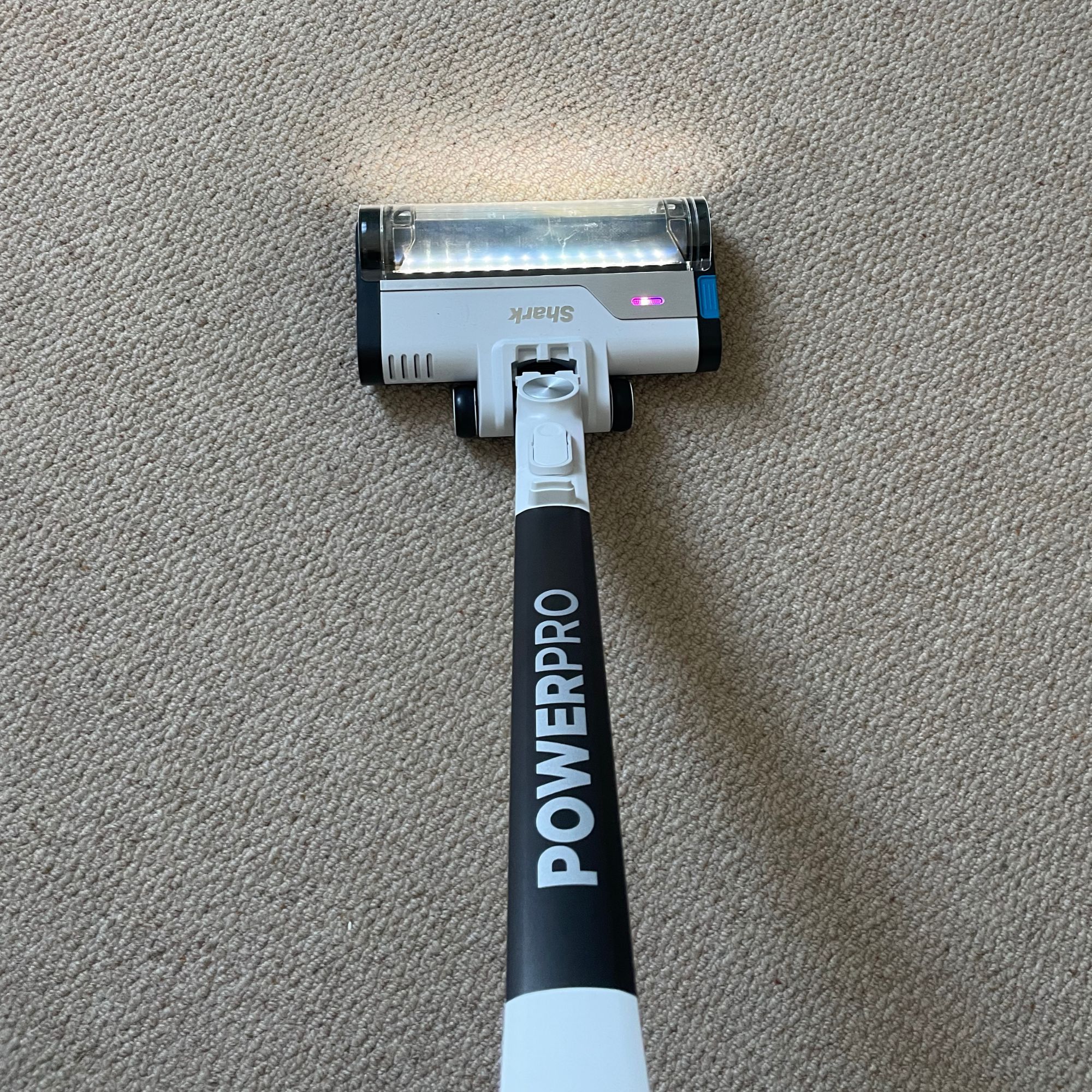 Shark PowerPro Pet Cordless Stick Vacuum on cream carpet