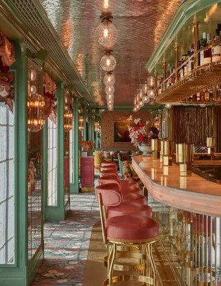 The extravagantly designed interiors of a hotel feature pastel-shaded colors, plush stools, a swanky bar counter, mirrored ceilings, and mosaic floors for an unparallel atmosphere.