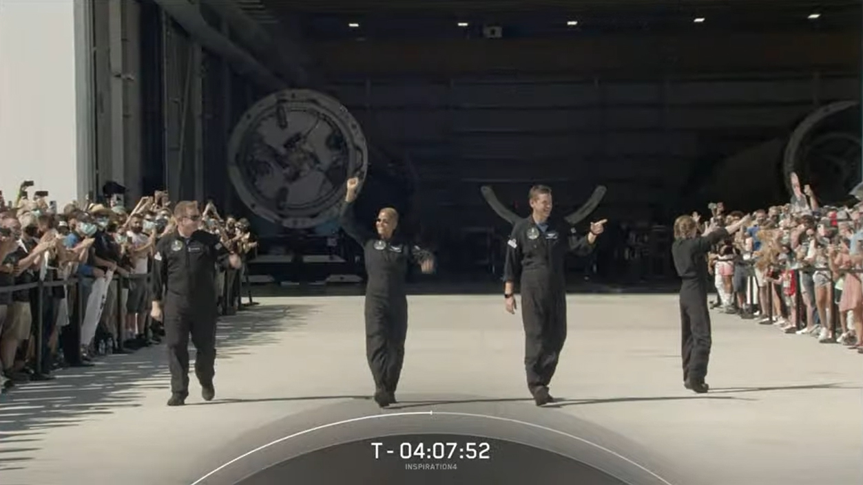 SpaceX's first all-civilian crew for the Inspiration4 mission walks out of Hangar X at Cape Canaveral Space Force Station to head to their launch pad on Sept. 15, 2021.