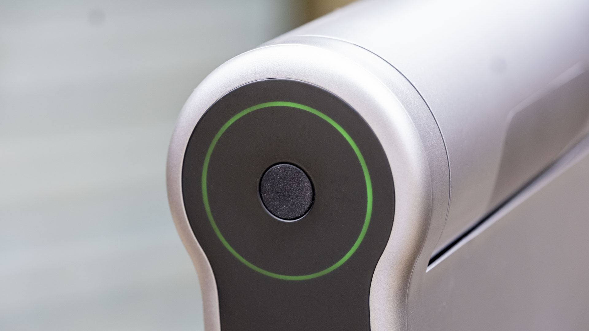 A close-up of the Dwarf III telescope showing the main power button and status ring