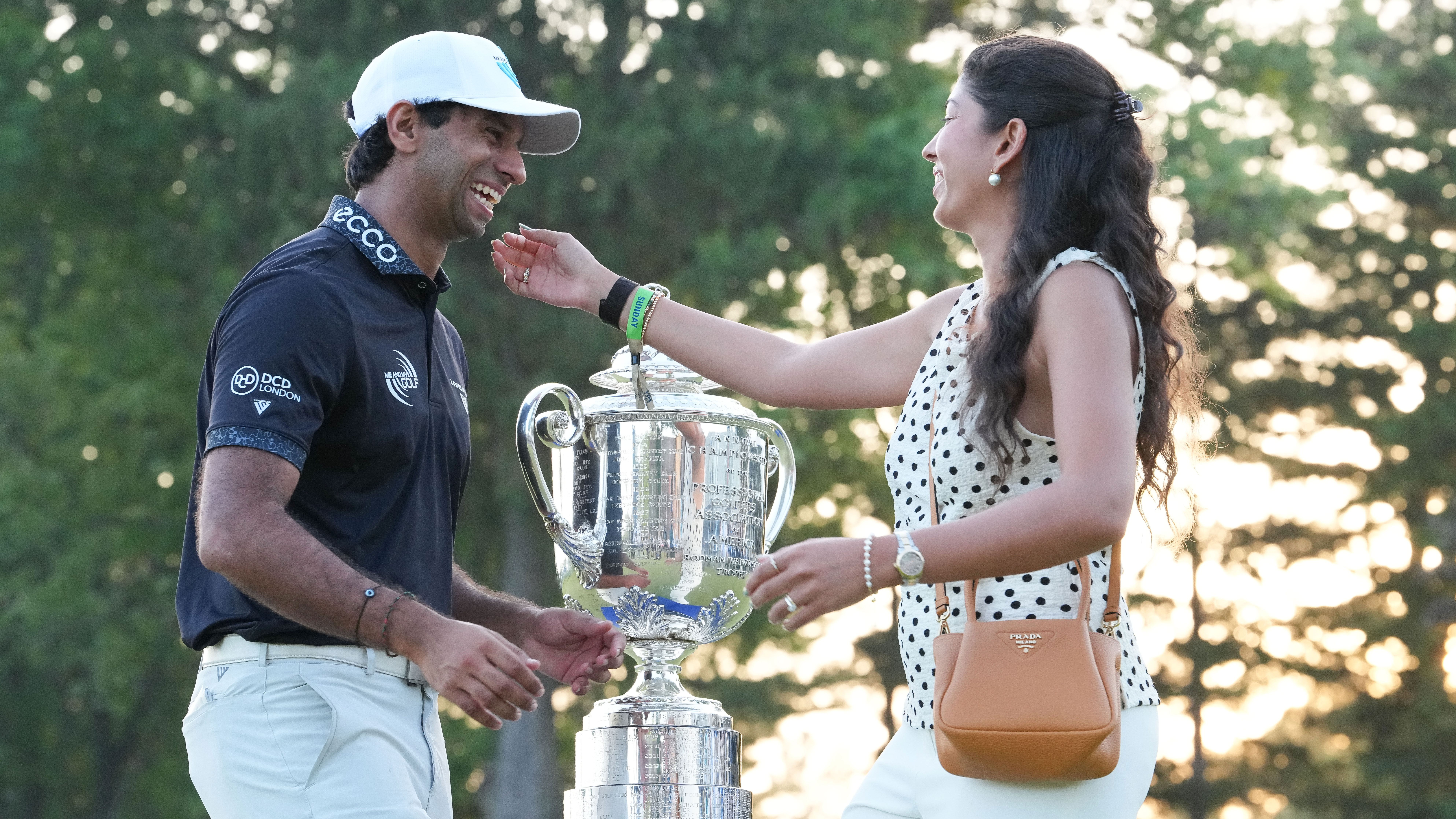 Aaron Rai celebrates with his wife Gaurika Bishnoi after winning the 2026 PGA Championship at Aronimink 