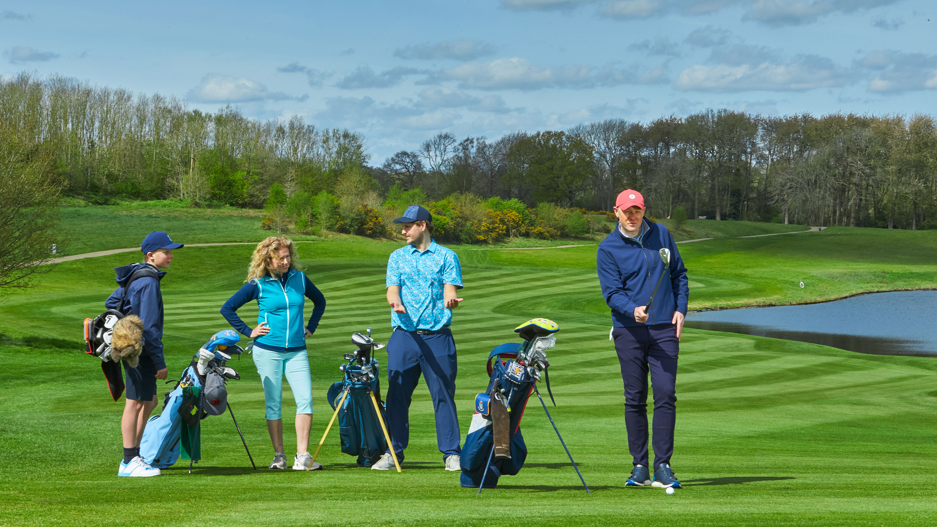 a golfer taking a long time on a pre-shot routine while three other golfers look on in annoyance
