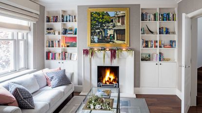 living room with open shelving, couch and fireplace