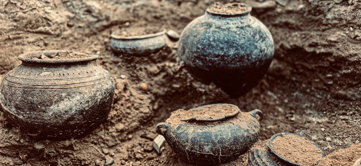 a collection of pottery jugs