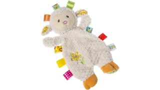 A lamb shaped soft cuddly toy with nine different coloured and patterned clothes tag attached to it's side.